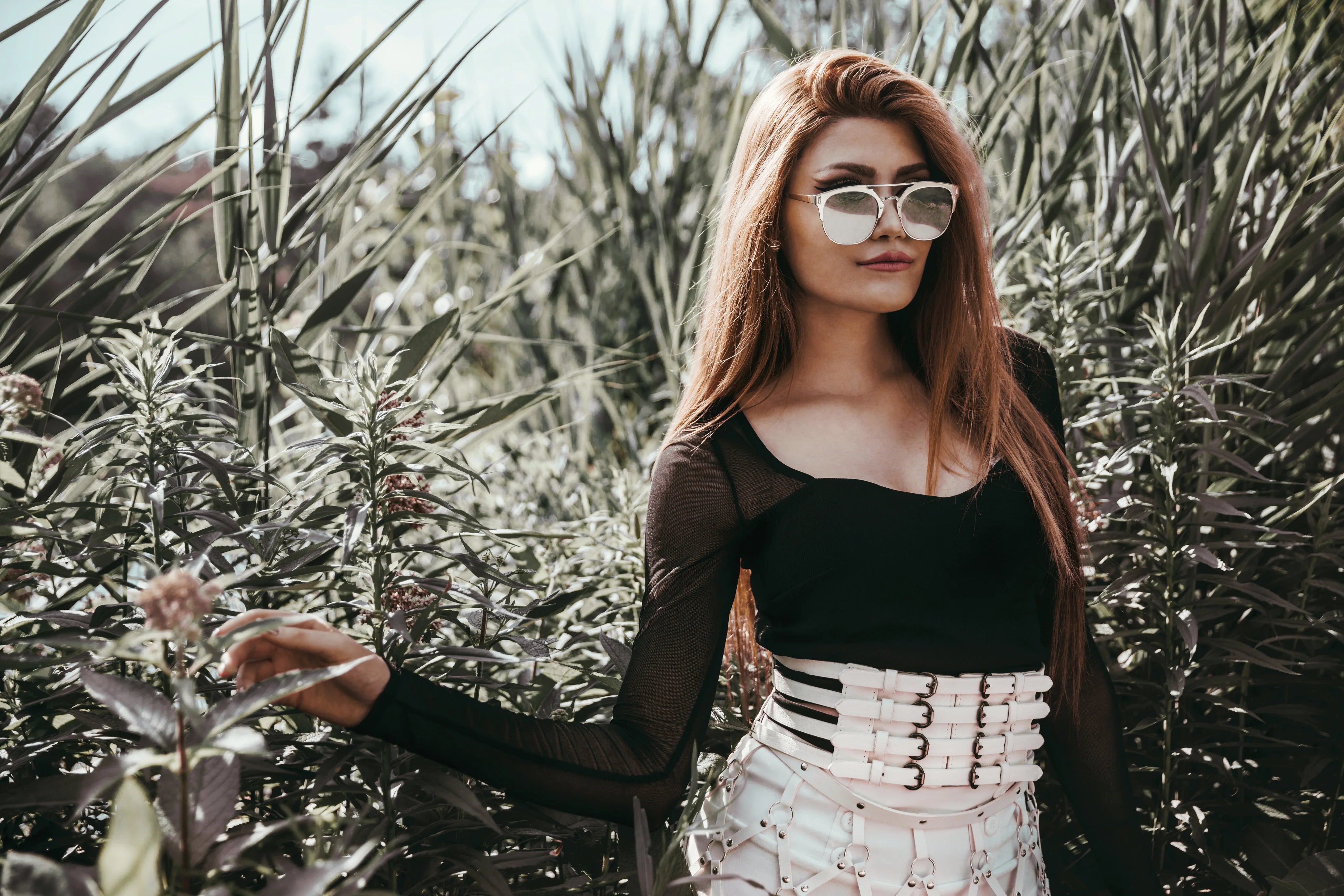 files/model-poses-near-bushes.webp